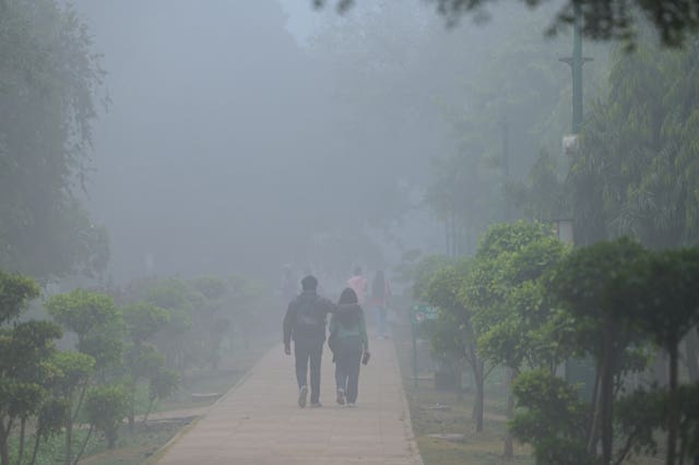 People walking in the smog