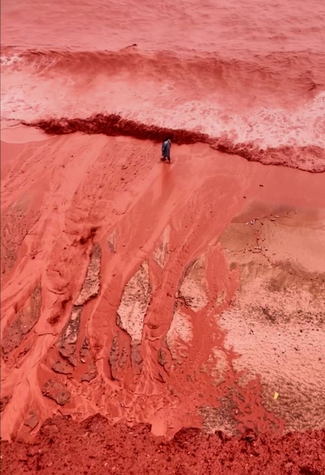 This picture, taken from video, shows how rainfall briefly transformed the coastline of its famed Red Beach into a striking natural scene on Iran’s Hormuz Island