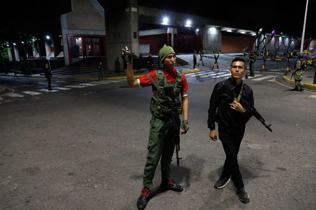Members of the presidential guard stand outside the Miraflores presidential palace in Caracas