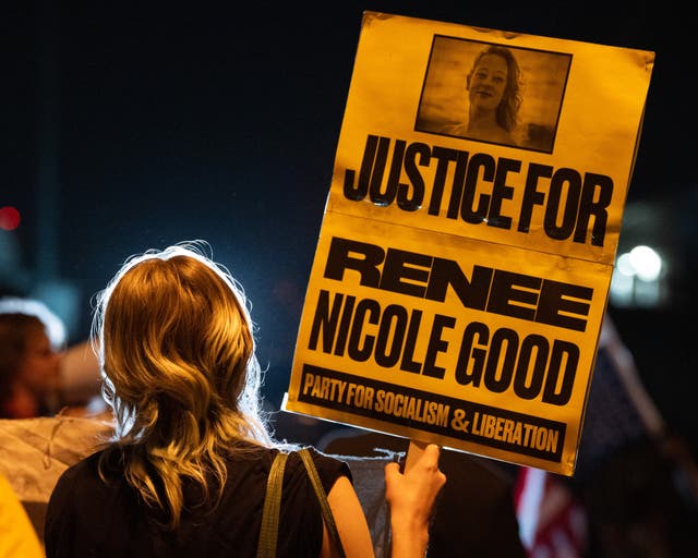 A woman holds a sign memorialising Renee Good as activists protest outside an ICE facility in Pflugerville, Texas