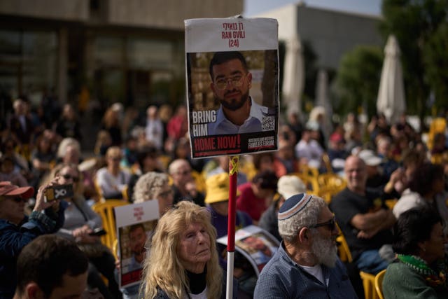 A woman in Tel Aviv, Israel, holds up a sign with a photo of Ran Gvili, who was killed while fighting Hamas militants during the October 7 2023 attack and whose body has been held in Gaza ever since