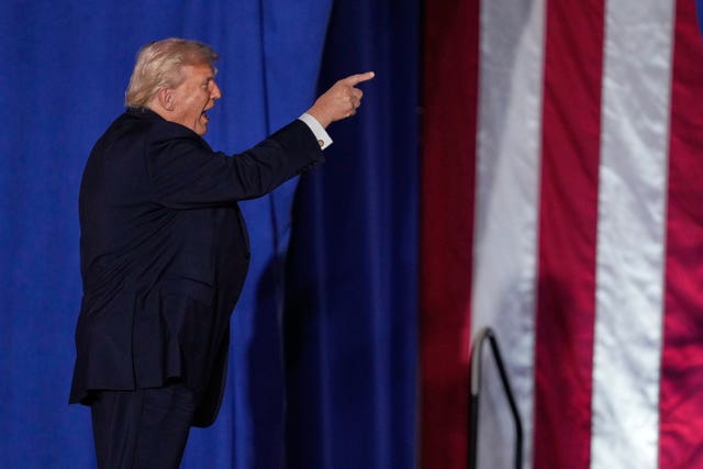 President Donald Trump points after speaking about the economy at a rally in Iowa
