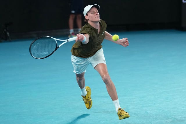Jannik Sinner lunges for a forehand