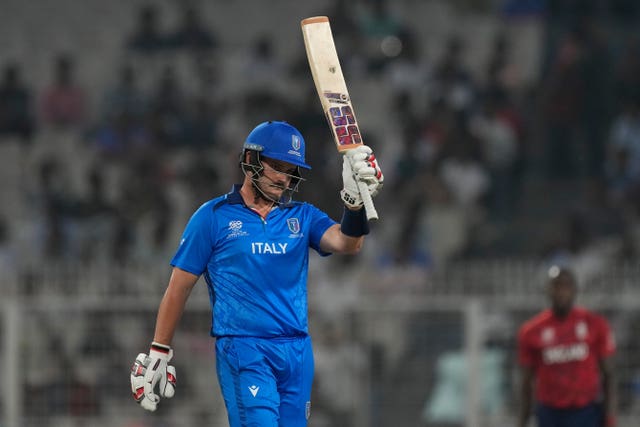 Ben Manenti raises his bat after reaching fifty