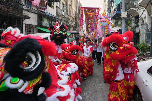 Chinese artists perform a lion and dragon dance in Myanmar