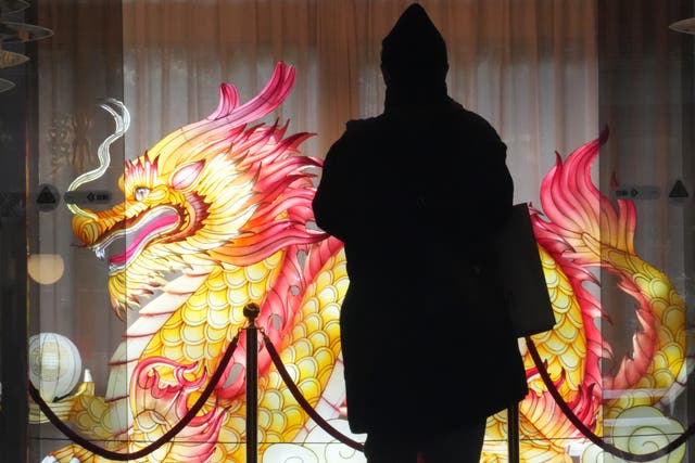 A visitor looks at a dragon lantern in China Town in Yokohama