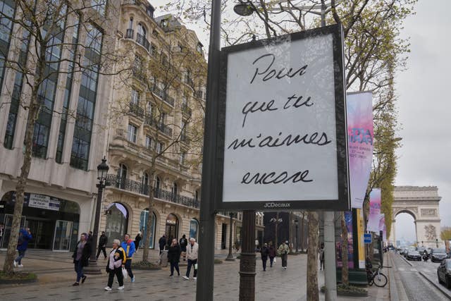A poster featuring the French title of Celine Dion’s song If That’s What It Takes, promoting autumn concerts in France on the Champs-Elysees in Paris