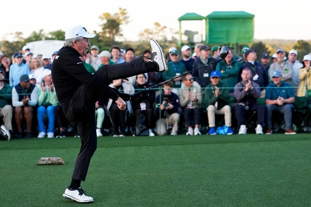 Gary Player kicks out his leg after teeing off in the Masters