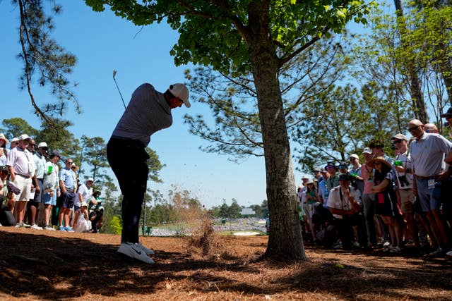 Rory McIlroy plays a shot from under the trees