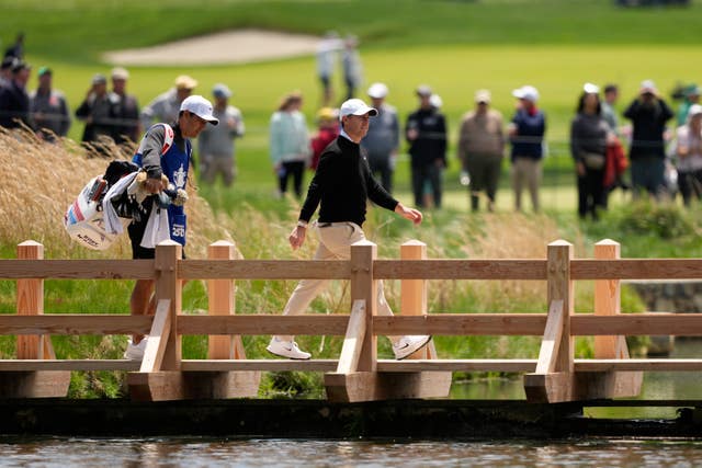 McIlroy crosses a bridge
