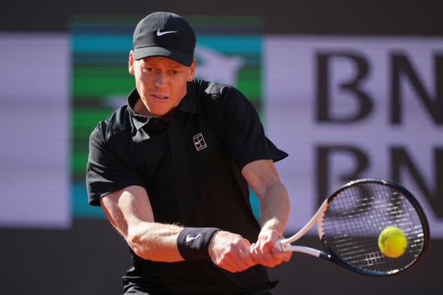 Jannik Sinner hits a backhand