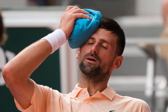Novak Djokovic applies an ice pack