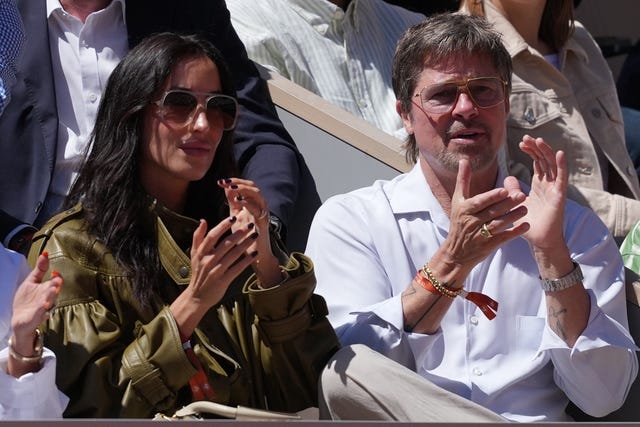 Brad Pitt, right, applauds