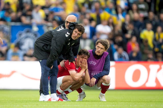 Denmark’s Joakim Maehle, Andreas Christensen, and Jens Stage react after Christian Eriksen collapsed on the field