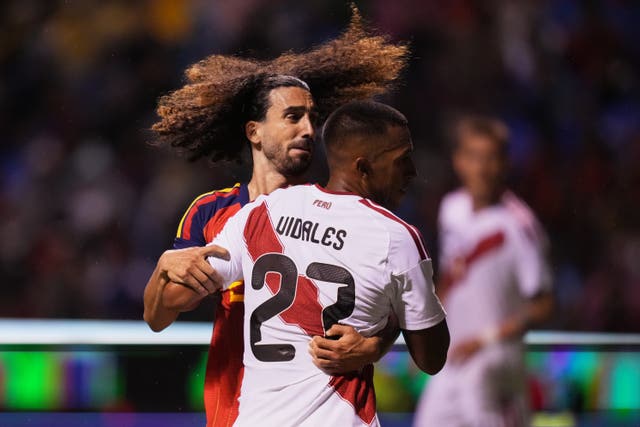 Peru’s Jhonny Vidales, front, and Spain’s Marc Cucurella fight for the ball