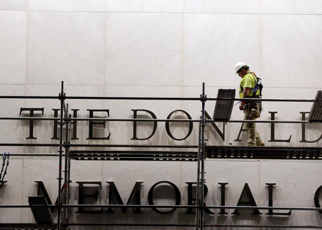Workers erect scaffolding in front of the John F. Kennedy Centre