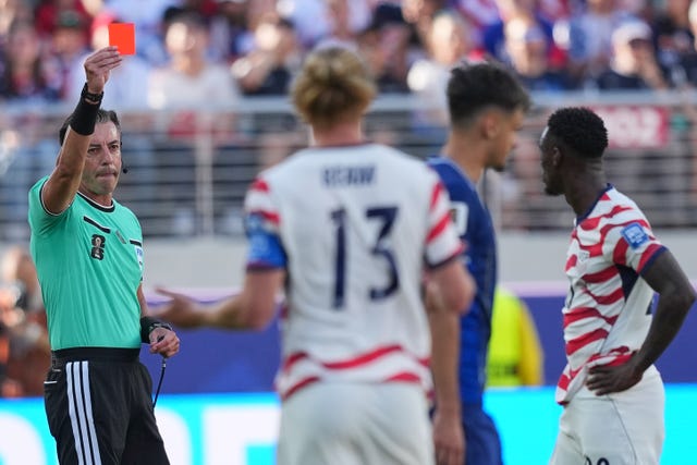 Referee Raphael Claus of Brazil shows a red card to United States’ Folarin Balogun, right,