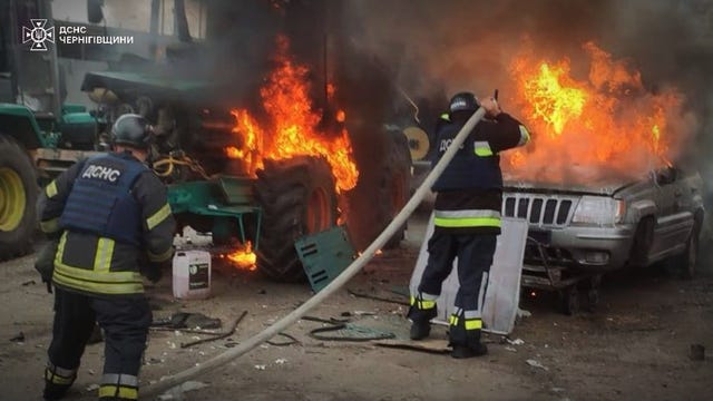 Emergency services personnel work to extinguish a fire following a Russian air attack in Chernihiv, Ukraine