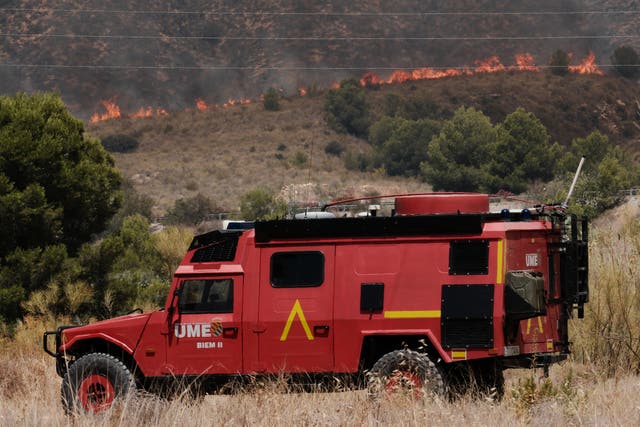 A military emergency unit vehicle operates as a wildfire rages in Alfajir, near Almeria in south-eastern Spain