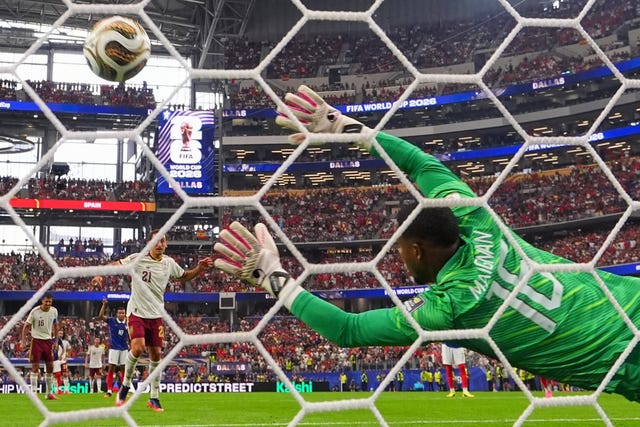 Spain’s Mikel Oyarzabal scores their first goal from the penalty spot against France keeper Mike Maignan in the World Cup semi-final in Dallas