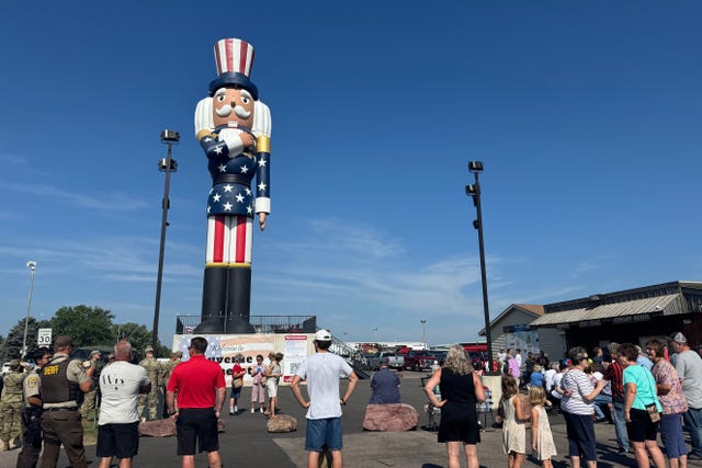 People gather for the ribbon-cutting ceremony for Verne the Patriot in Luverne, Minnesota