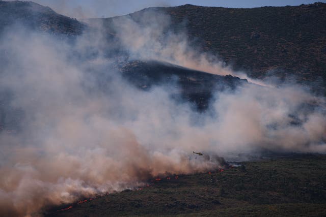 Smoke and flames rise as a wildfire advances near Burgohondo in Spain