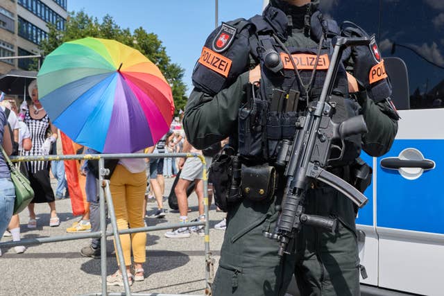 An armed police officer stands near the Hamburg Pride event