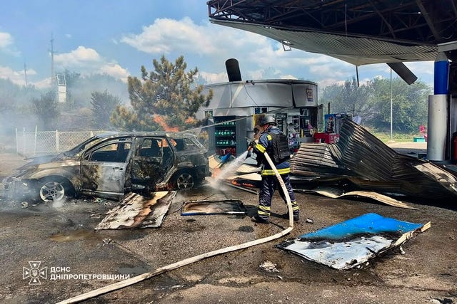 Firefighters put out a fire at a petrol station following a Russian drone attack in Dnipropetrovsk region, Ukraine