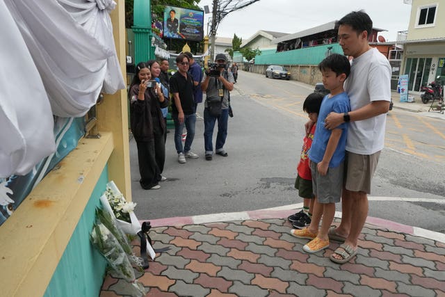 People offer prayers at the gate of Debsirin Nonthaburi School