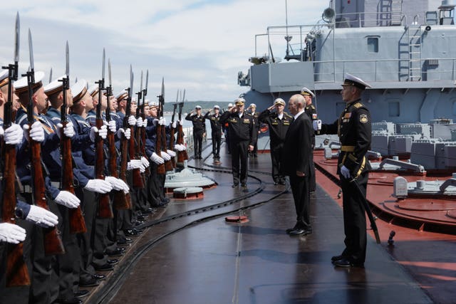 Russian President Vladimir Putin, second right, visits the Varyag missile cruiser