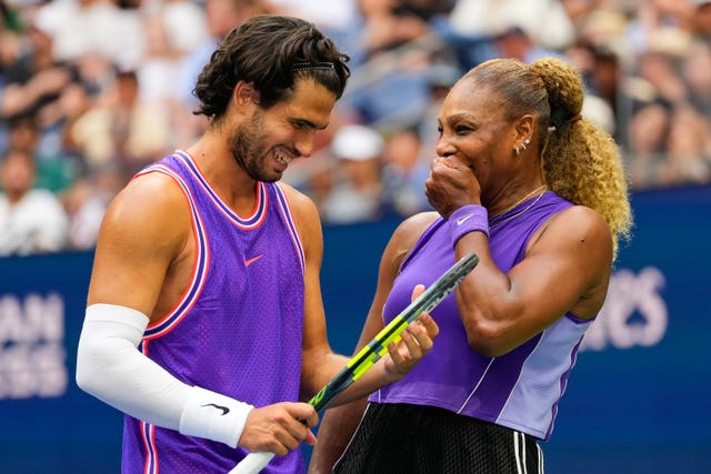 Carlos Alcaraz, of Spain, left, and Serena Williams, of the United States, talk on the court during a mixed doubles match