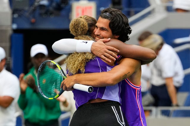 Carlos Alcaraz, right, hugs Serena Williams after victory over Lloyd Glasspool and Erin Routliffe, not pictured