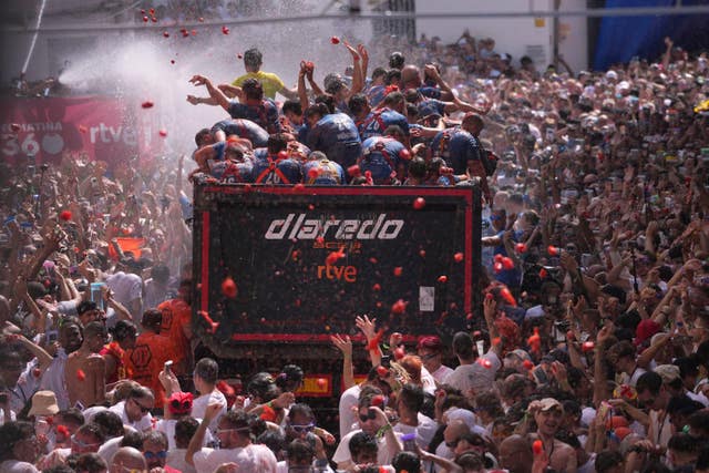 Revellers throw tomatoes at each other during the annual Tomatina tomato fight fiesta
