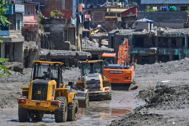 Earthmovers clear the debris of flash flooding in Nepal’s Nuwakot district