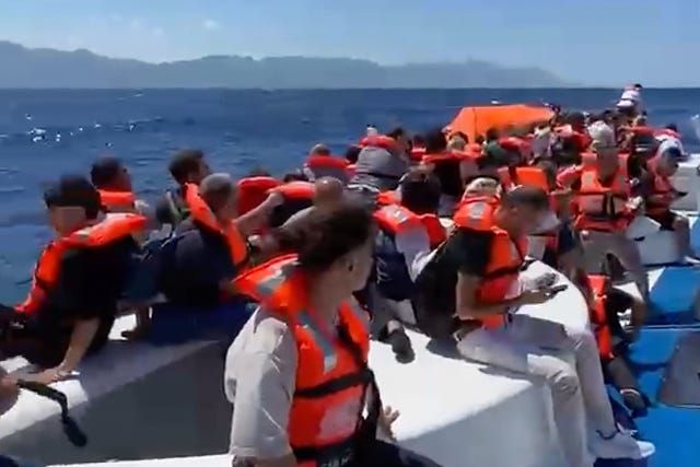 People in lifejackets on board a boat
