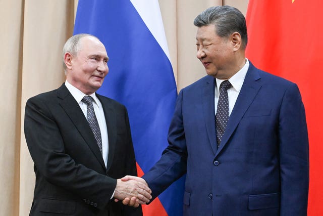 Russian President Vladimir Putin, left, and China’s President Xi Jinping shake hands during their meeting on the sidelines of the Shanghai Co-operation Organisation in Kyrgyzstan