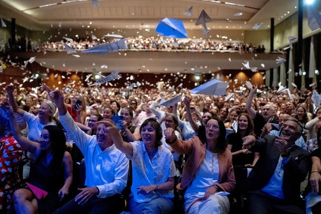 Spectators throw paper planes during the Ig Nobel prize ceremony in Zurich