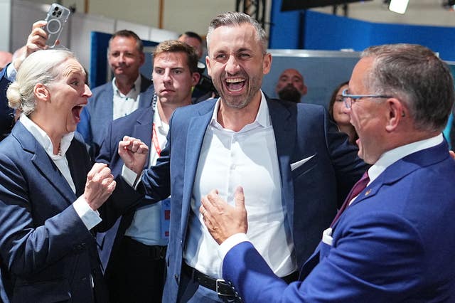 Ulrich Siegmund, centre, celebrates with Alice Weidel and Tino Chrupalla