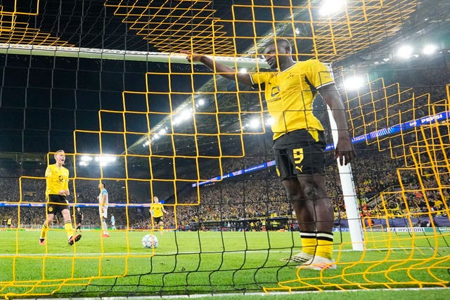 Borussia Dortmund’s Serhou Guirassy in the net celebrating his first goal against Villarreal