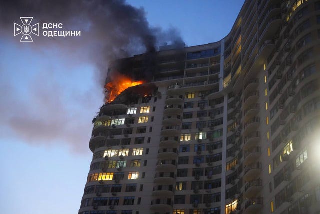 View of the top of a high-rise building, with flames visible