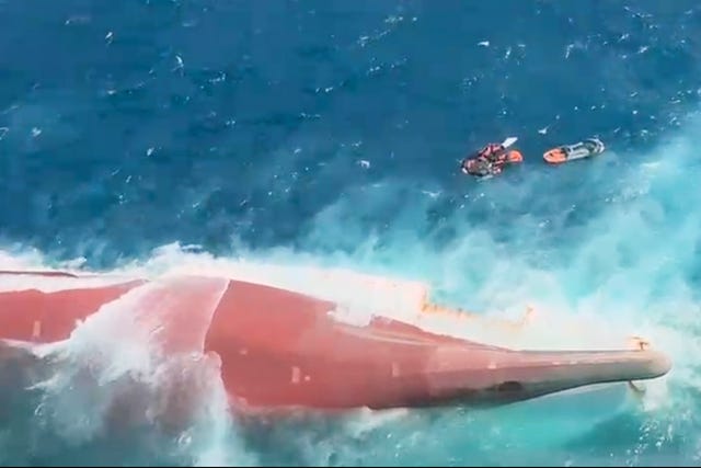 In this aerial image taken from video released by Indonesia’s National Search and Rescue Agency (BASARNAS), the bottom of passenger ferry Virgo Transport 8 is seen above the water after it overturned in bad weather in the Java Sea,