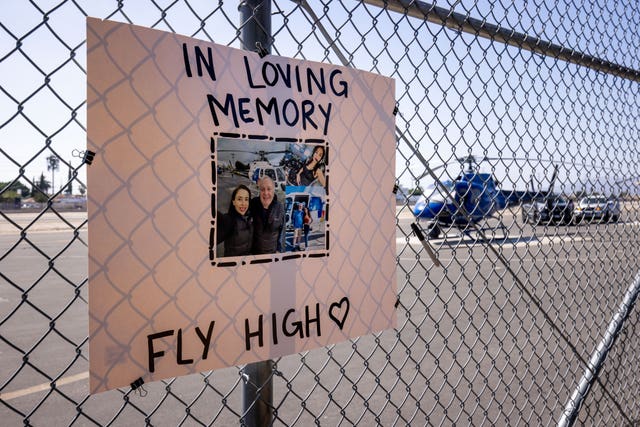 A memorial sign on a fence