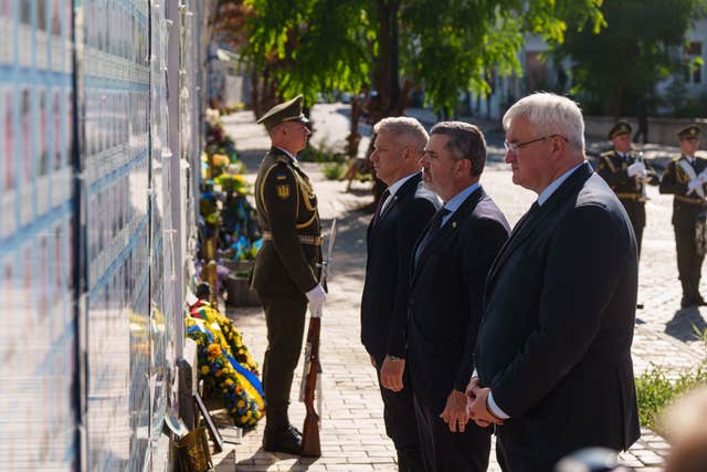Ministers from Slovenia and Ukraine lay flowers at a memorial in Kyiv