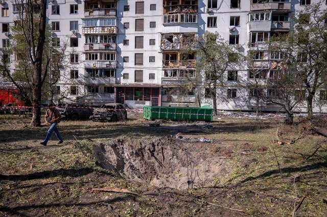 A missile crater near a damaged apartment building following a Russian air attack on Kyiv