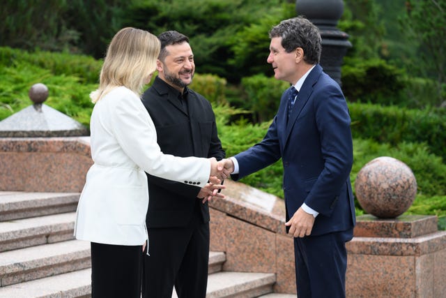 Romanian President Nicusor Dan, right, is welcomed by Ukraine’s President Volodymyr Zelensky and his wife Olena Zelenska at the Carpathian Eight summit