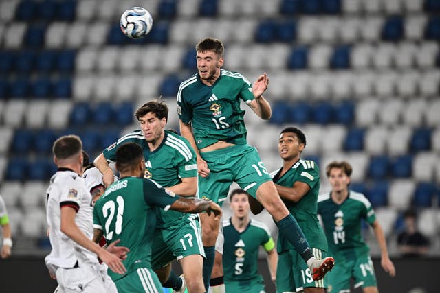 Northern Ireland’s Ruairi McConville, top, heads clear against Georgia