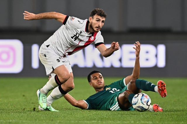 Northern Ireland’s Shea Charles, right, makes a sliding challenge against Georgia