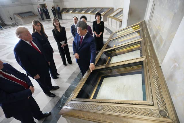 US President Donald Trump, first lady Melania Trump, China’s President Xi Jinping and his wife Peng Liyuan, view the constitution, bill of rights and other documents at the National Archives in Washington