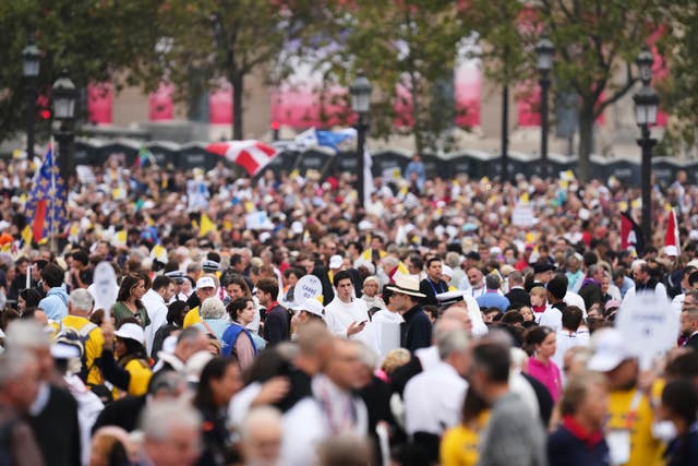 People wait for the arrival of Pope Leo XIV