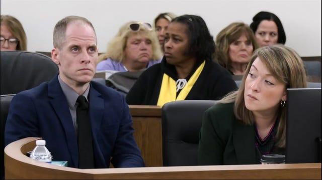 Caleb Flynn alongside his lawyer in court